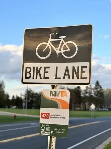 White sign with a bicycle symbol above the words BIKE LANE