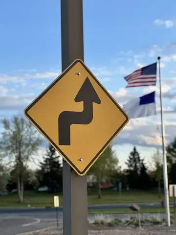 Yellow diamond sign showing an arrow bending right then left