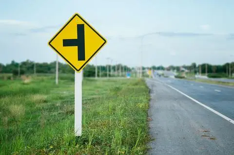Yellow diamond sign showing a side road joining from the left