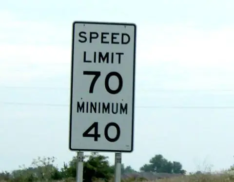 White sign reading SPEED LIMIT 70 with MINIMUM 40 below