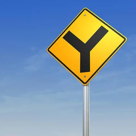 Yellow diamond sign showing a black Y shape for a Y intersection ahead